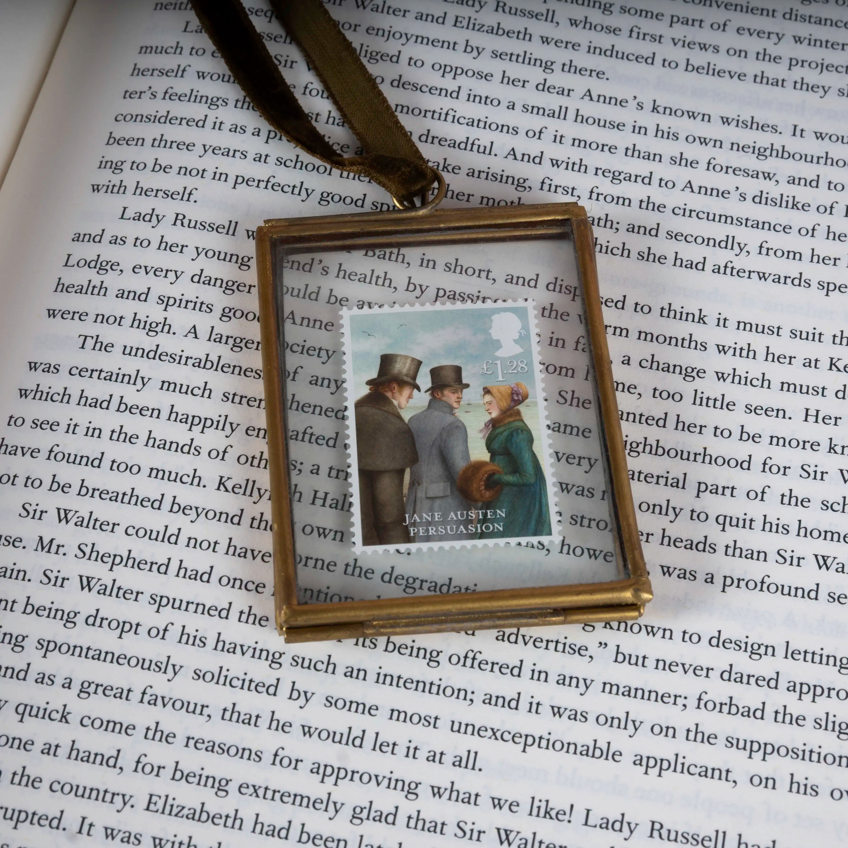 Square pendant with a photo of two people on a book page
