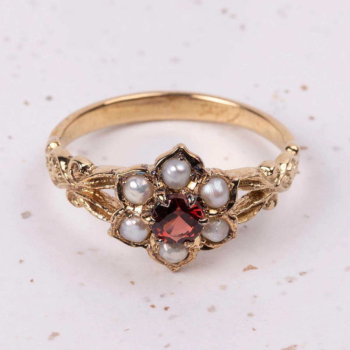 Close Up of Regency Ring with Garnet and Pearl Flower design