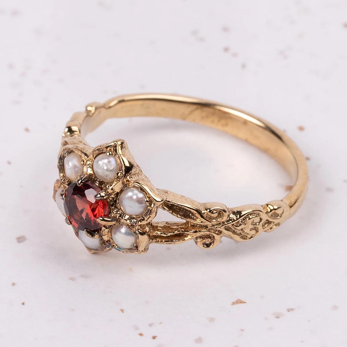 Close Up of Regency Ring with Garnet and Pearl Flower design