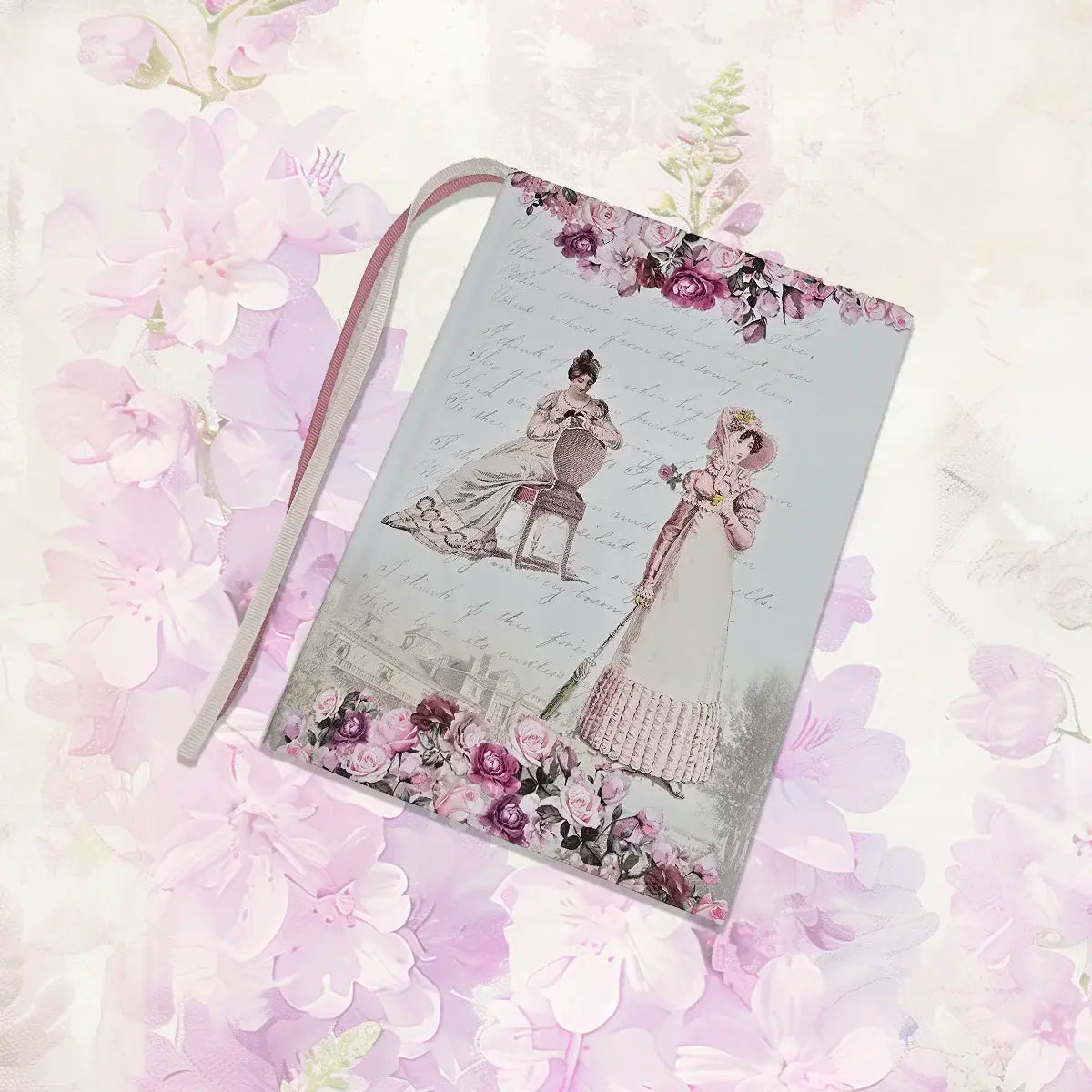 Notebook with floral design and illustration of two people on a soft pink floral background