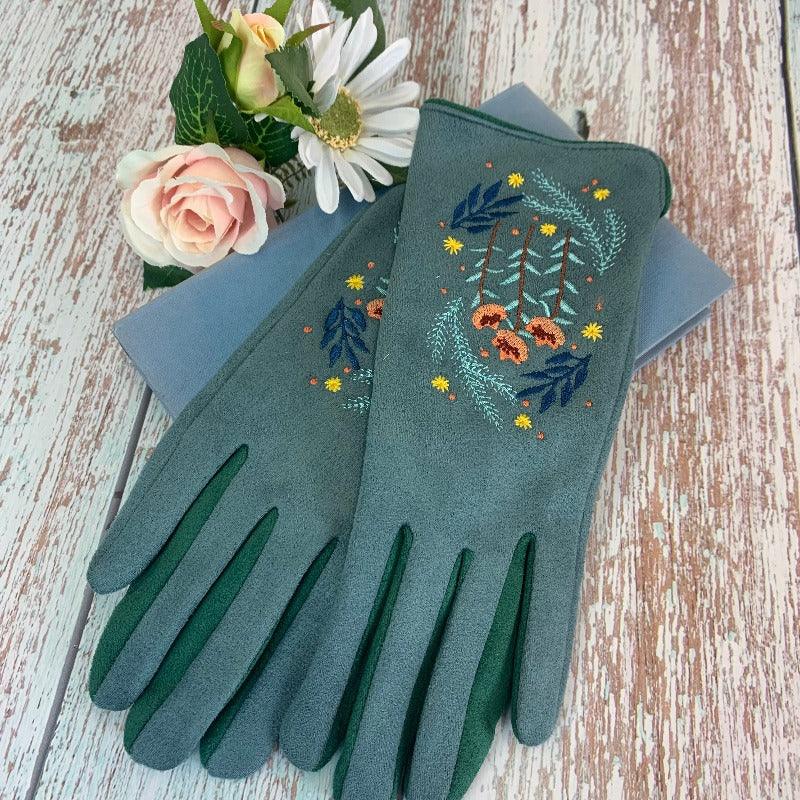 Green cotton gloves with pink, green, blue, and yelllow embroidered design on it, reminiscent of regency embroidery designs