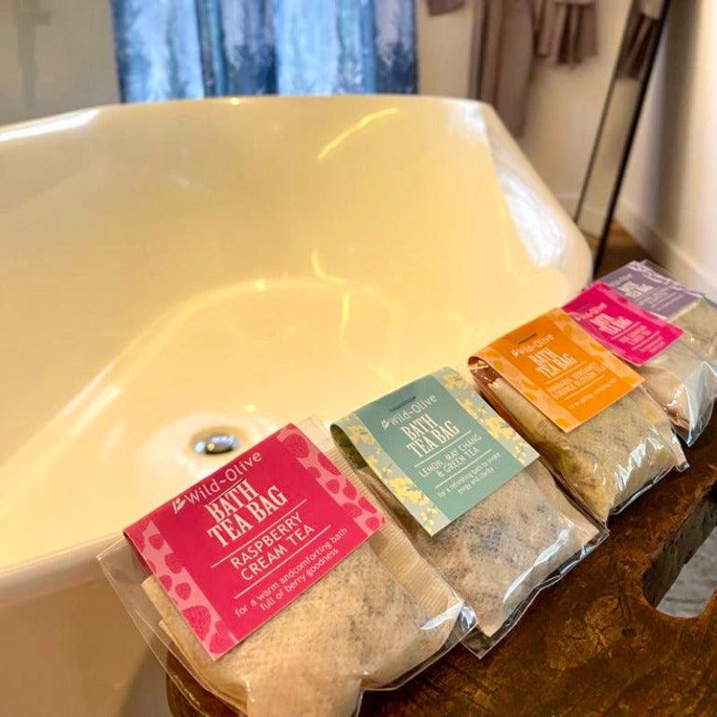The regency bath set is laid out next to a lovely bathtub. They are arranged next to each other to show off the exquisite scents