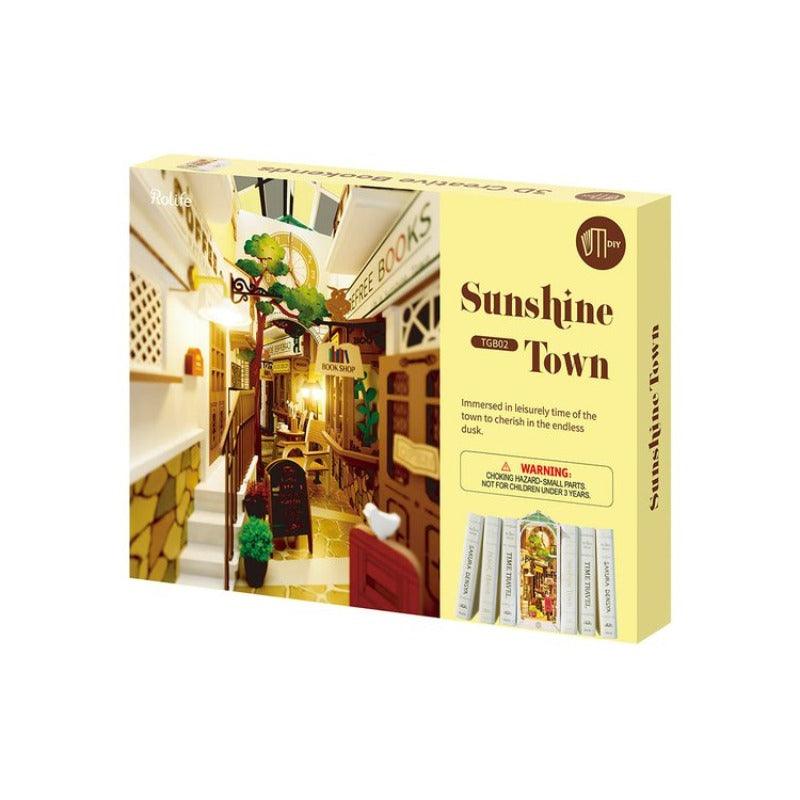 here you can see how the puzzle will arrive to you. In a flat pack box, from which you can see all the wooden pieces, glue and paper for you to build this adorable little town. 