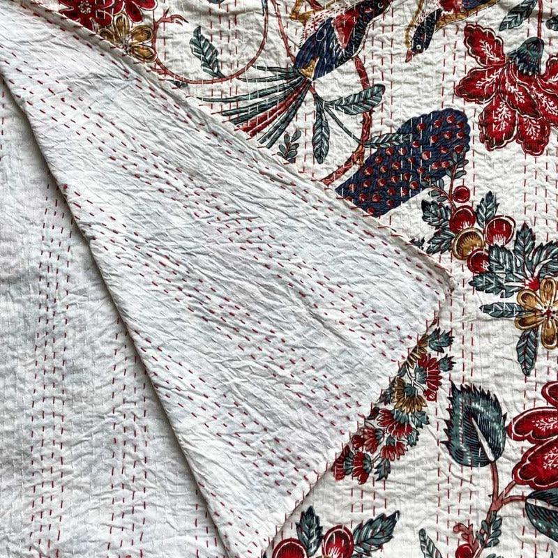 The pemberley blanket gently folded over the display the back sides traditional back stitching in a rich red coloured thread