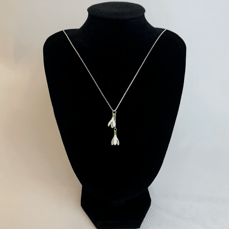 Here the snowdrop necklace is displayed hanging from a mannequin. Here you can see the pure white colour or the snowdrops and how they let the silver chain sparkle