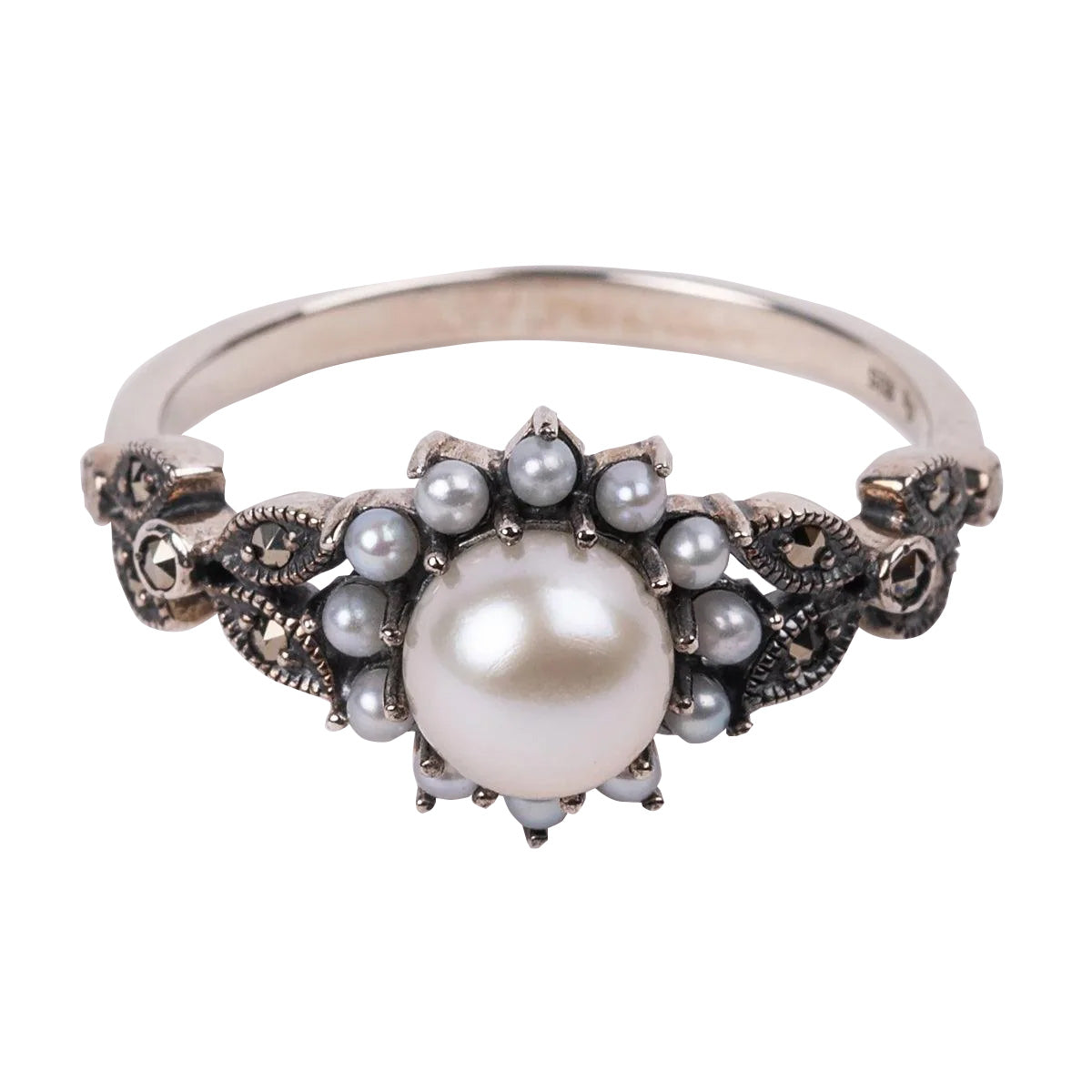 A sterling silver ring featuring a central pearl with marcasite stones, set on a band with ornate detailing.