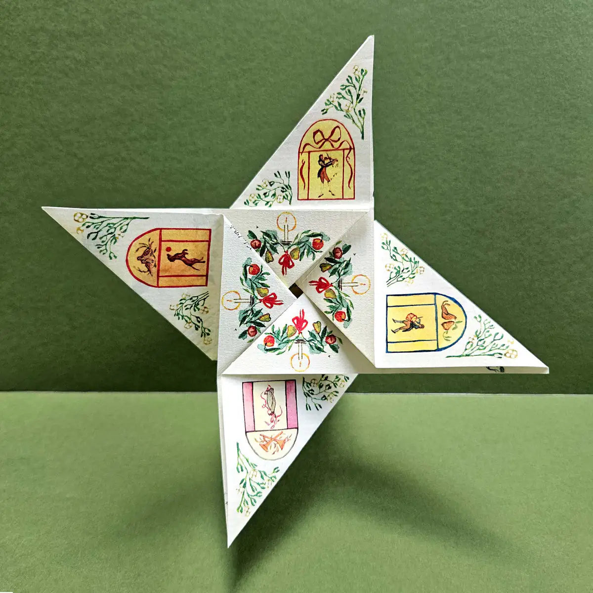 Decorative paper star with intricate designs on a green background