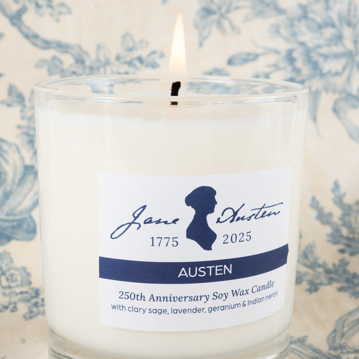 Candle with a Jane Austen label on a decorative background