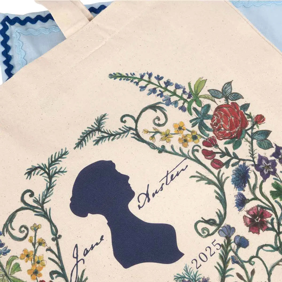 Close-up image of the Tote Bag anniversary pattern - navy Jane Austen silhouette surrounded by delicately painted flowers and ferns