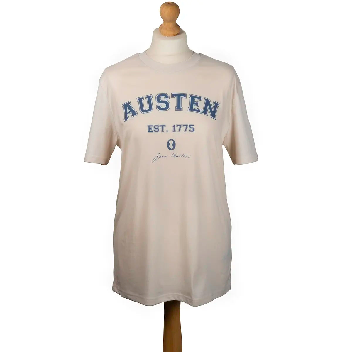 Cream shirt with 'AUSTEN EST. 1775' and Jane Austen silhouette in blue print, on a mannequin against a white background