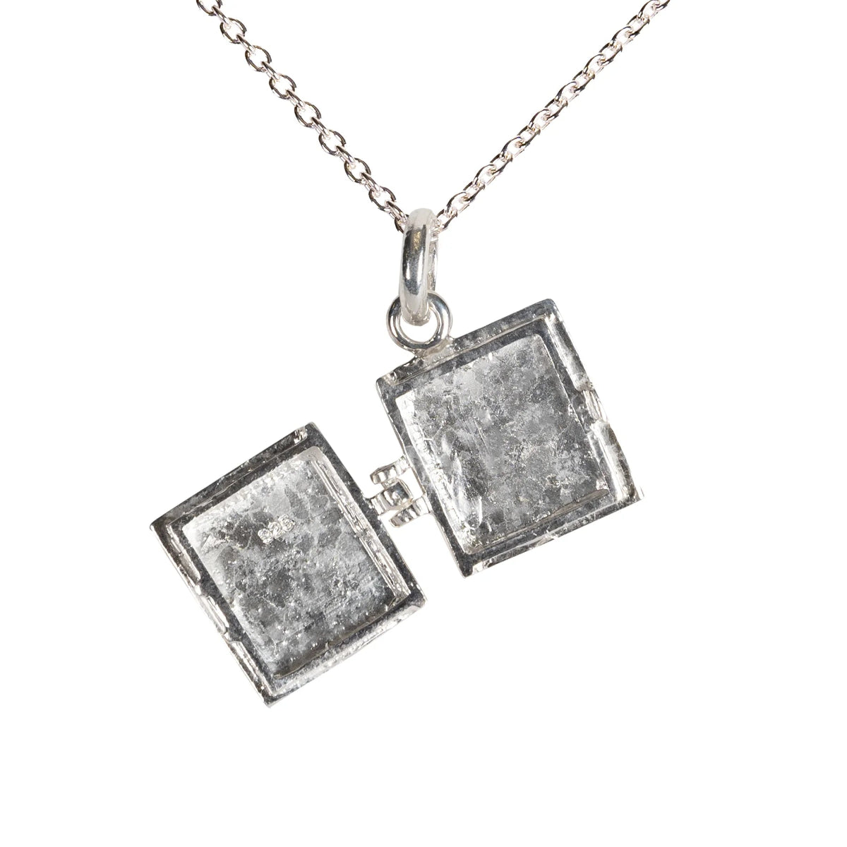 Open silver charm on a white backgound.