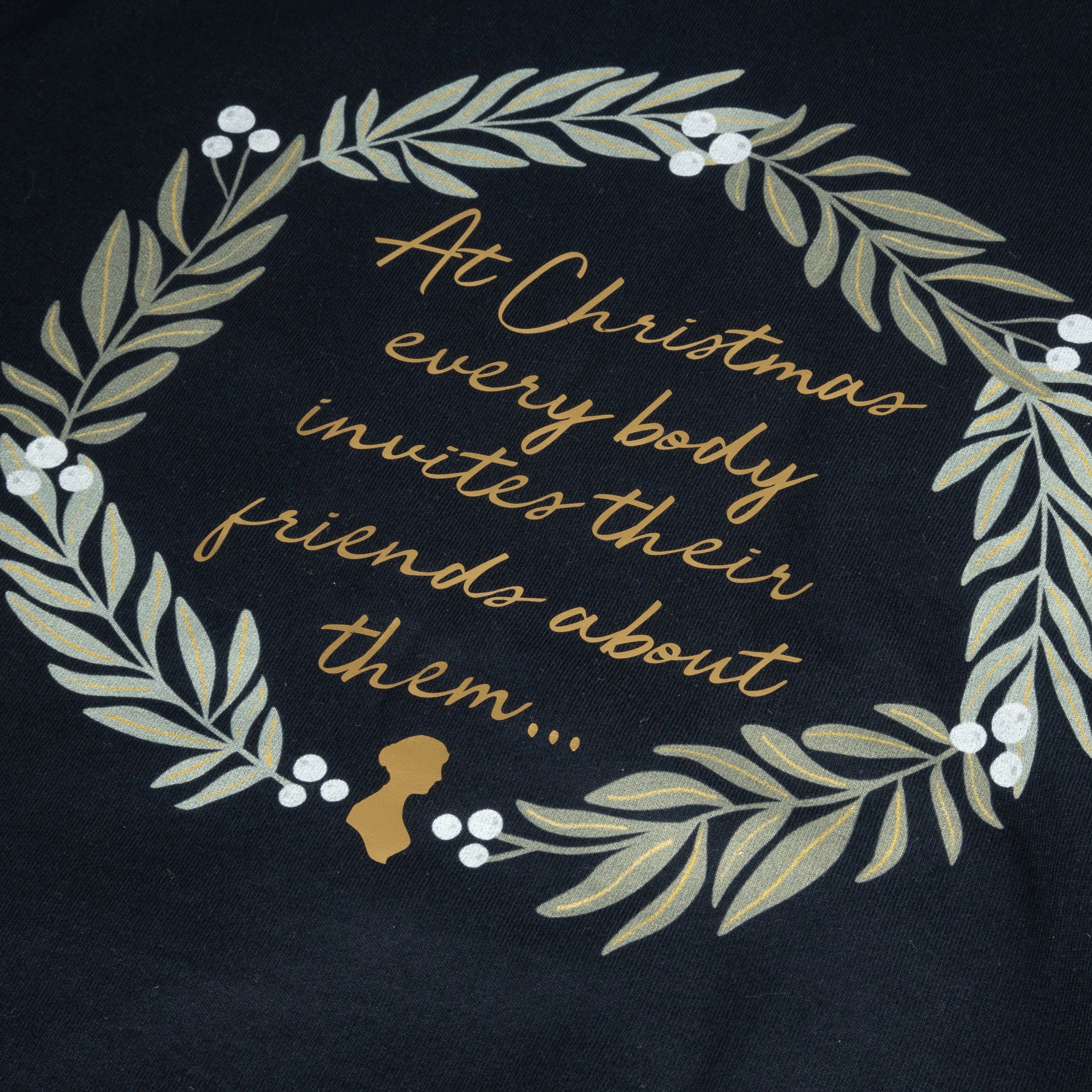 Closeup of navy sweater with a quote "At Christmas everybody invites their friends about them"