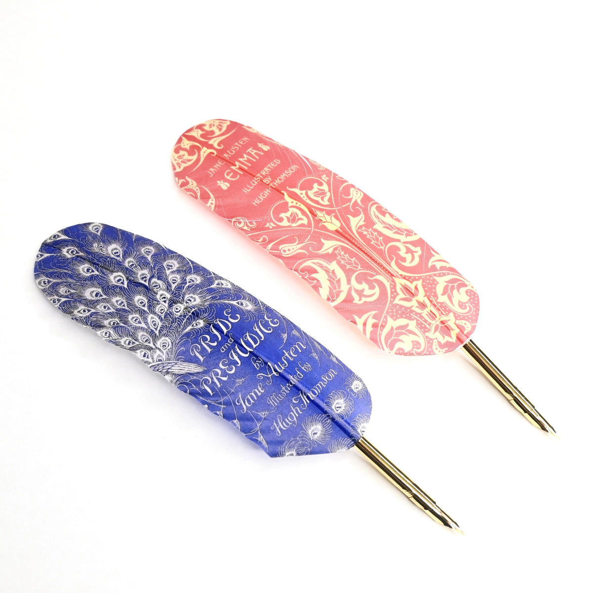 Two feather quills with gold gilded tips- one blue and one red.