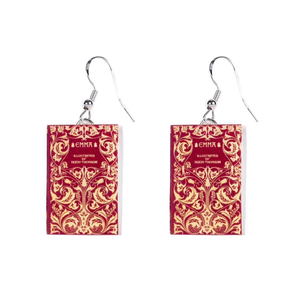 A pair of silver-plated earrings designed to resemble book covers, with intricate embossed designs and the title 'Emma' by Jane Austen written on the front.