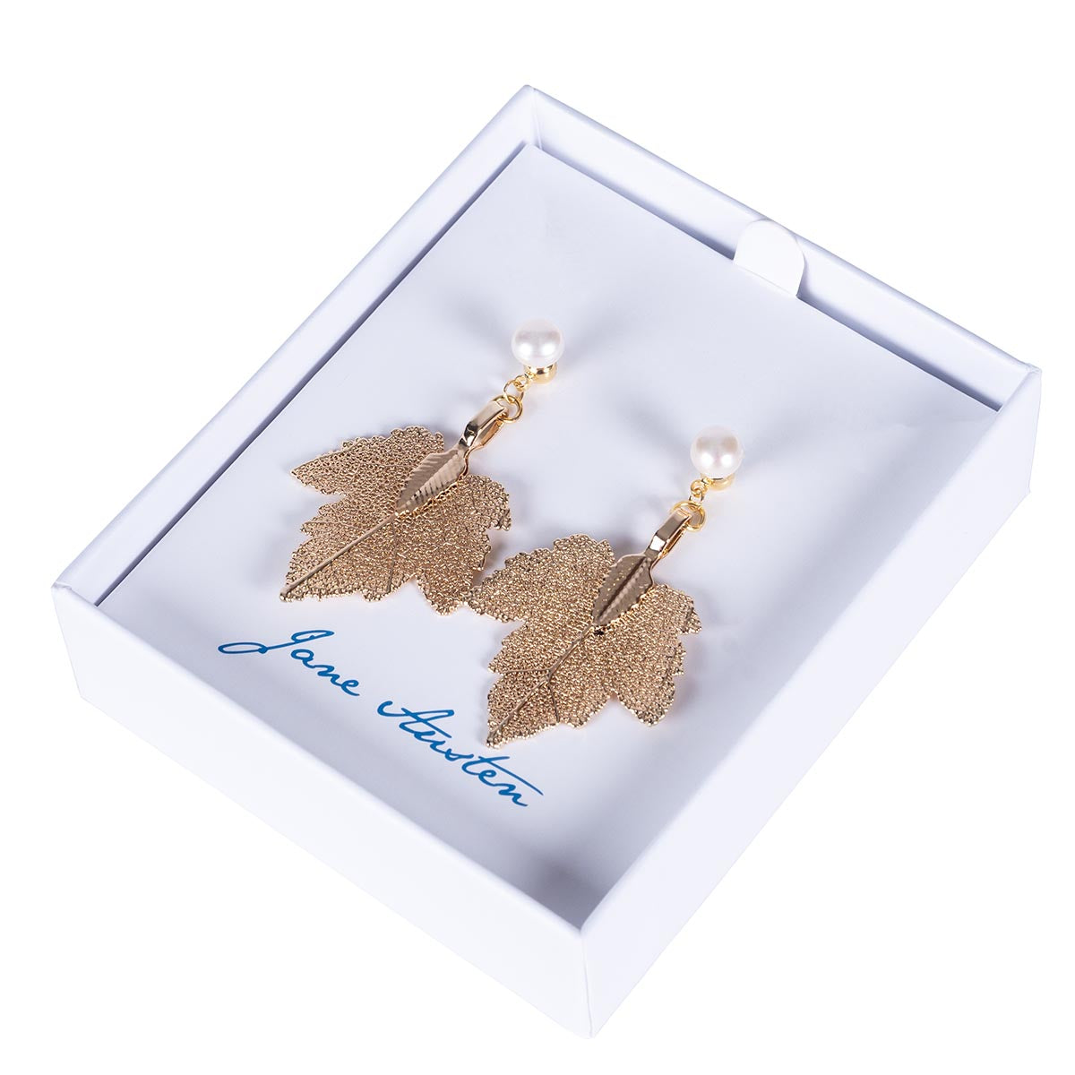 Pearl Earrings with a filigree gold leaf hanging below in a white box