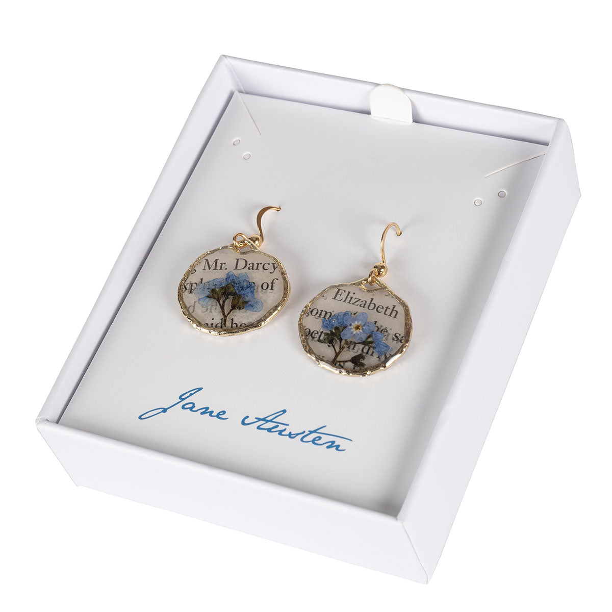 Jane Austen Book Page Earrings featuring pressed Forget Me Not flowers and text from Pride and Prejudice in a white jewellery box with Jane Austen writing