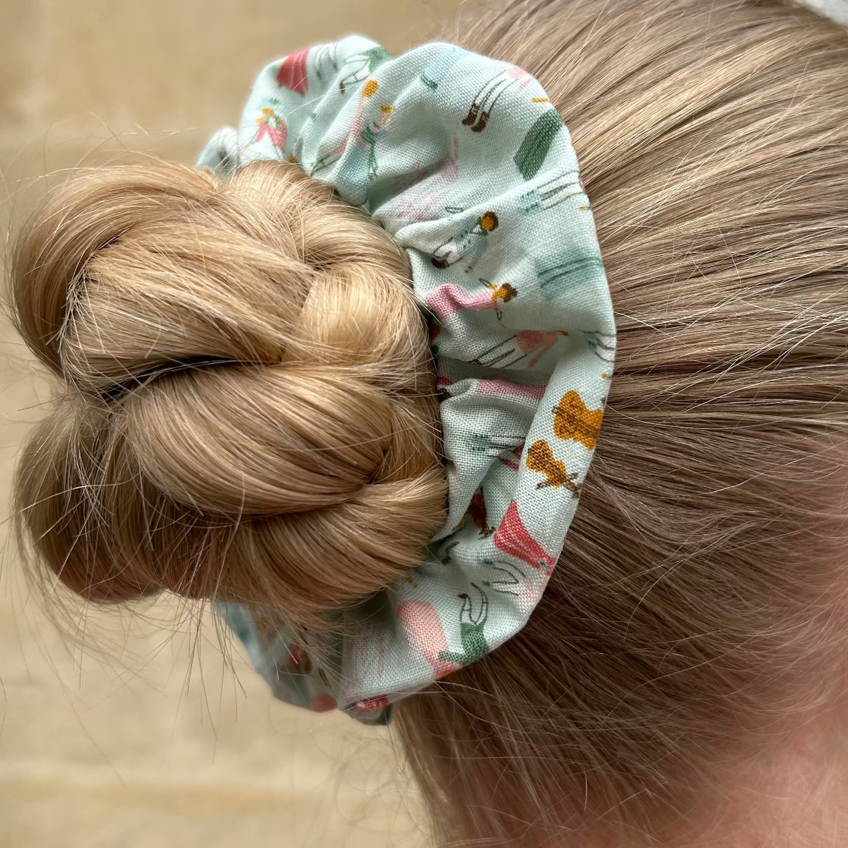 Close-up of the Regency Ball Scrunchie shown on hair in a bun. 