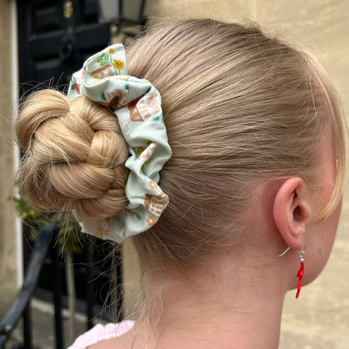 Regency House Scrunchie shown on hair in a bun. 
