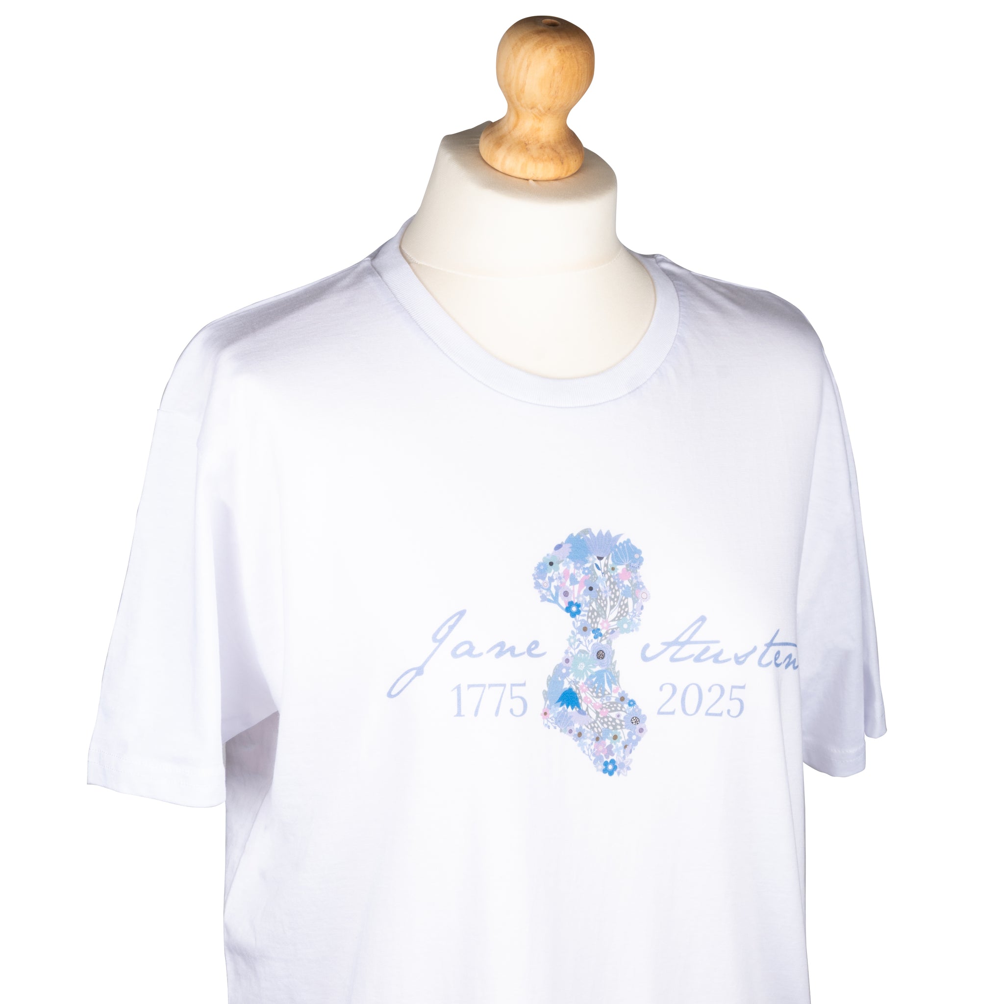 Mannequin wearing size M. Jane Austen 250th Anniversary T-Shirt in White. Silhouette of Jane is filled with flowers in cool tones and text 'Jane Austen 1775-2025' is in a cool tone of blue.