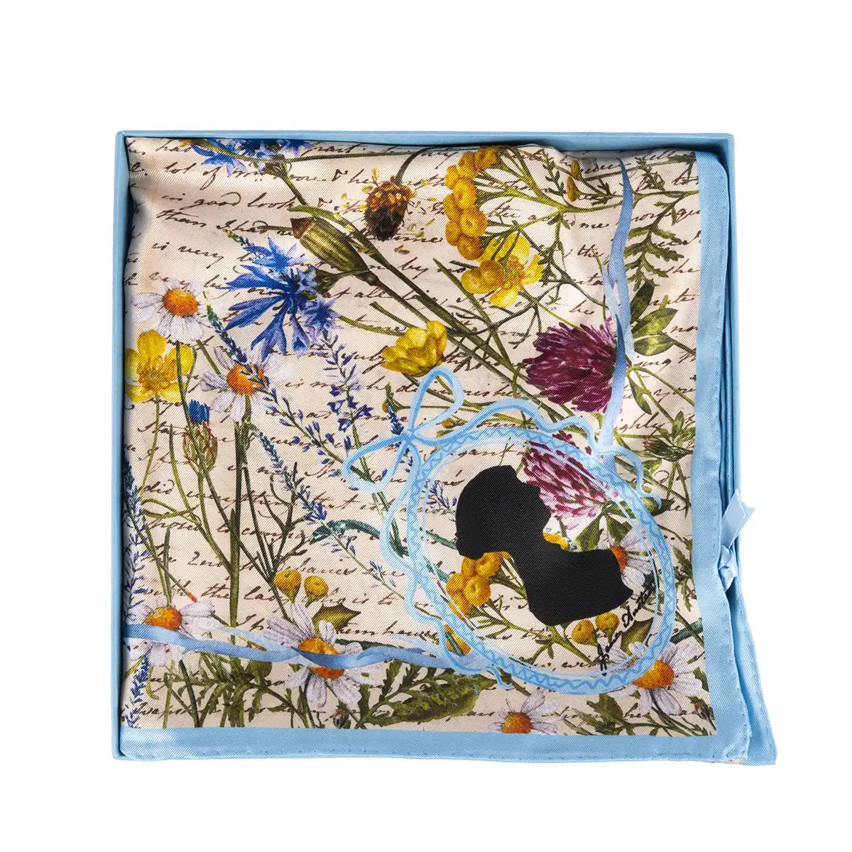 Silk scarf folded neatly into the blue box