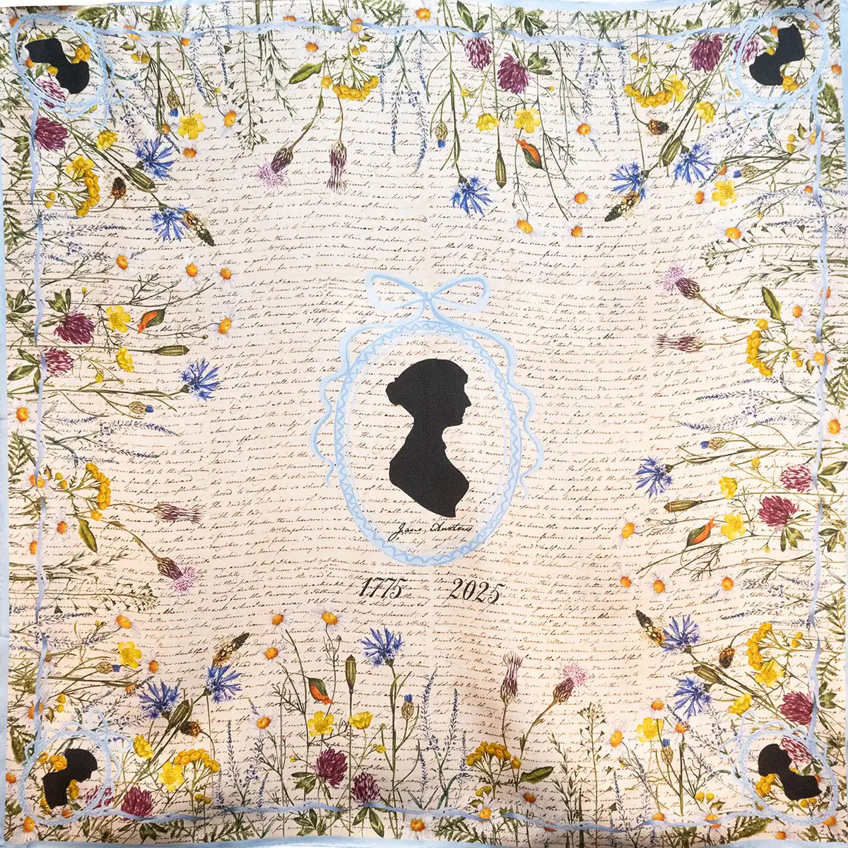 Silk scarf with Jane Austen's silhouette in the middle, surrounded by an illustration of a ribbon in pale blue. Meadow flowers line the edges of the scarf in a square. Dates 1775-2025.