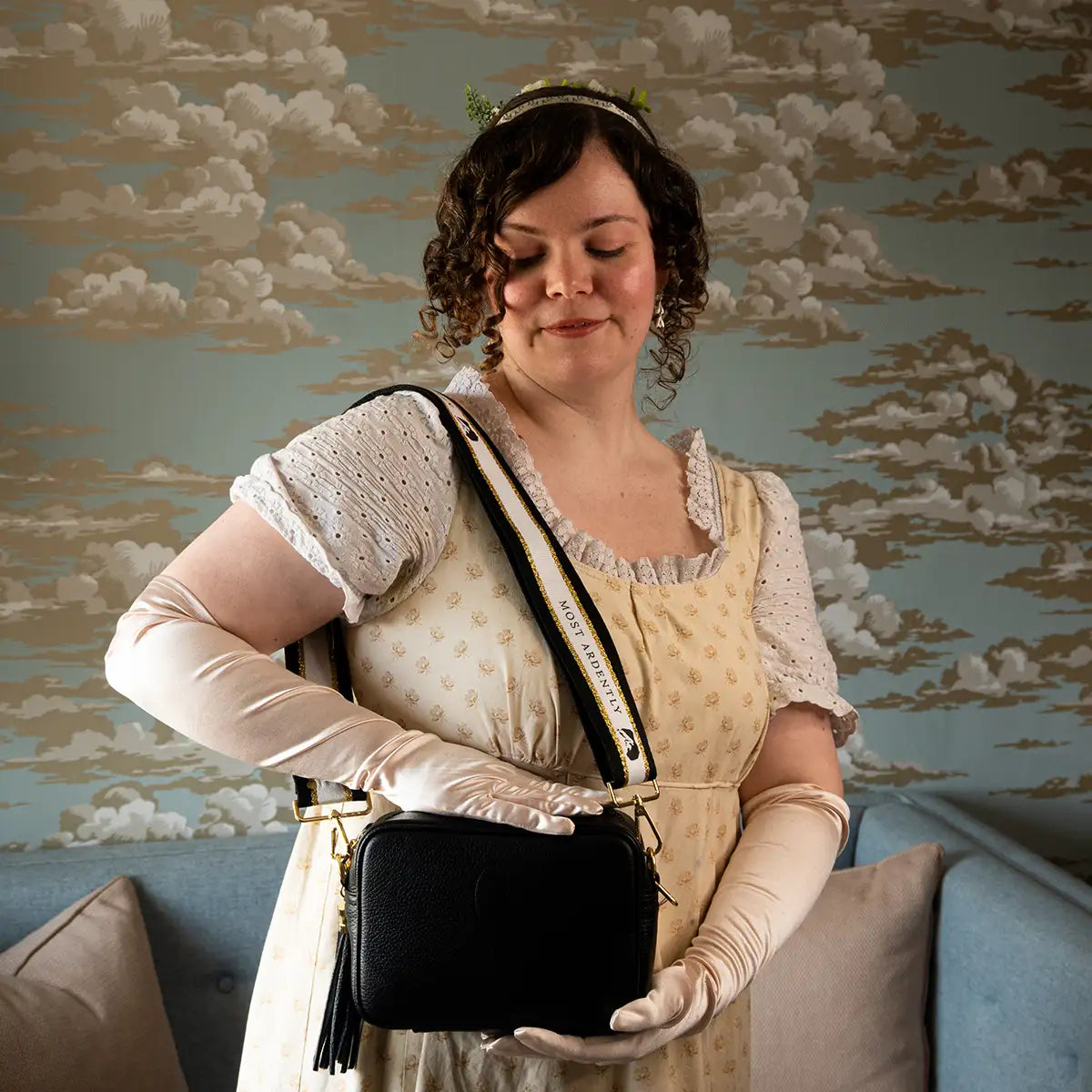 Model carrying leather handbag in black