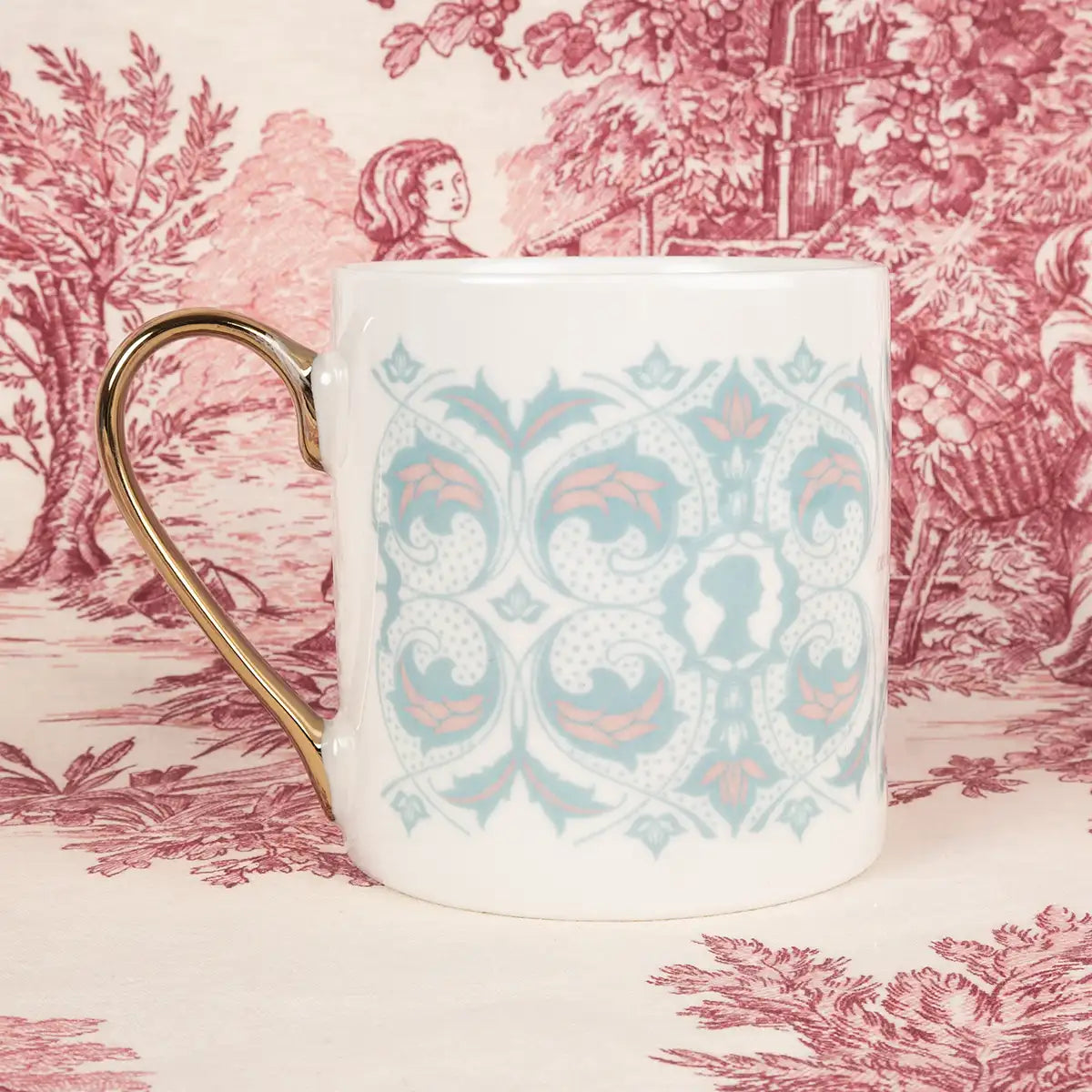 White mug with decorative pattern in pastel green and pink on a floral background