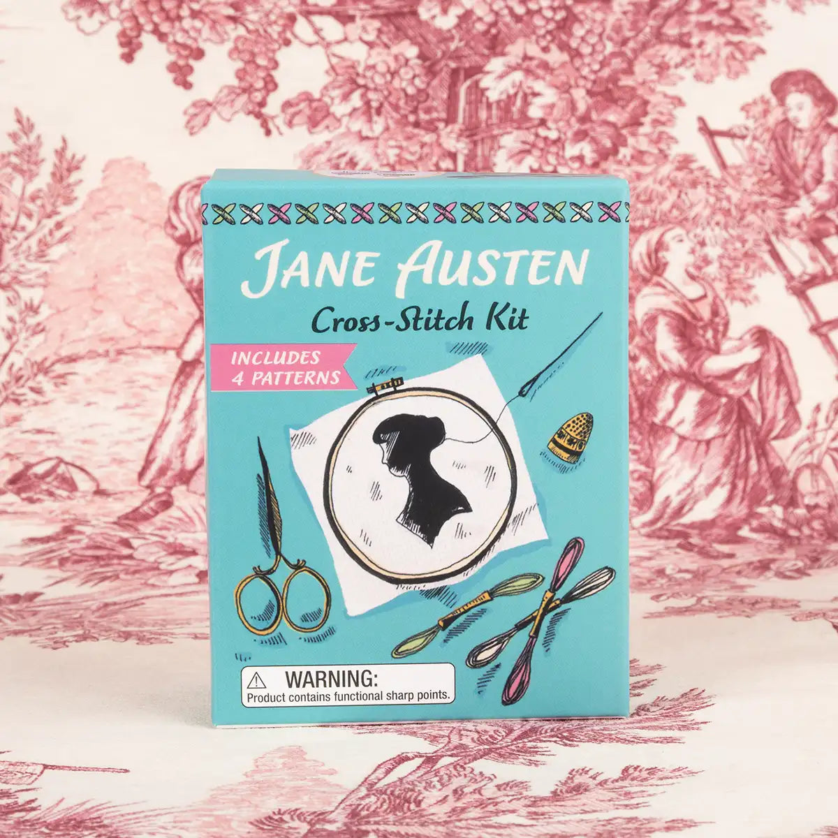 Cross-stitch kit packaging with Jane Austen design on a decorative background