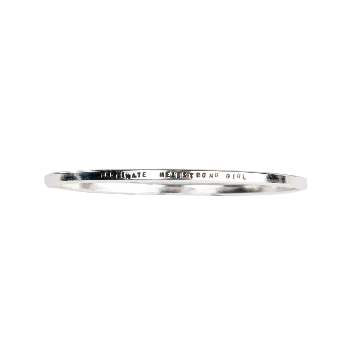 Bracelet with "Obstinate Headstrong Girl" stamped into it, shown against white background