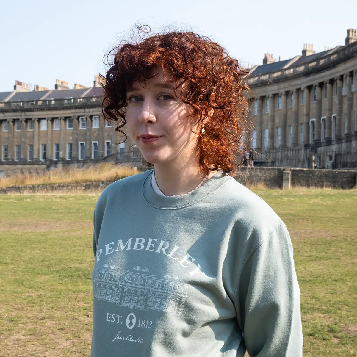 Model wearing sweater in Green by Royal Crescent, Bath.
