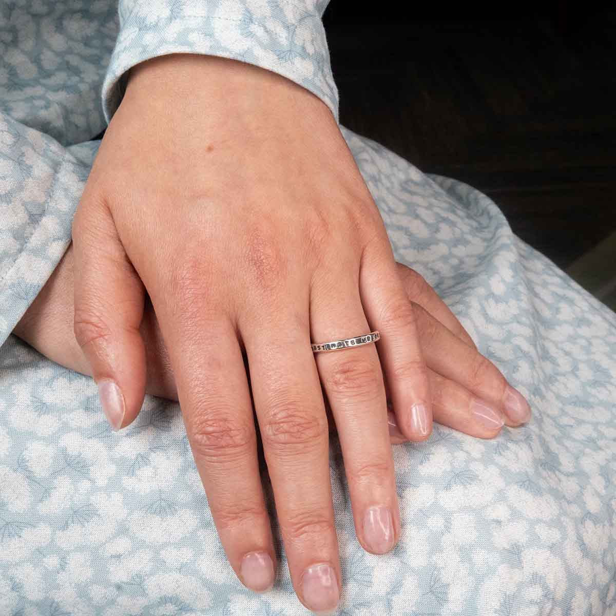 Ring on a finger with hands crossed.