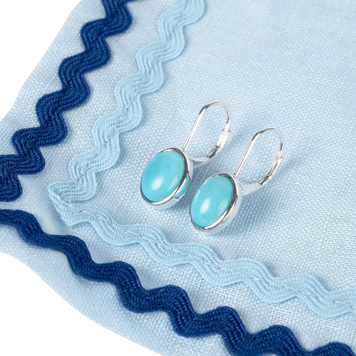 Earrings set on a blue cloth fabric 