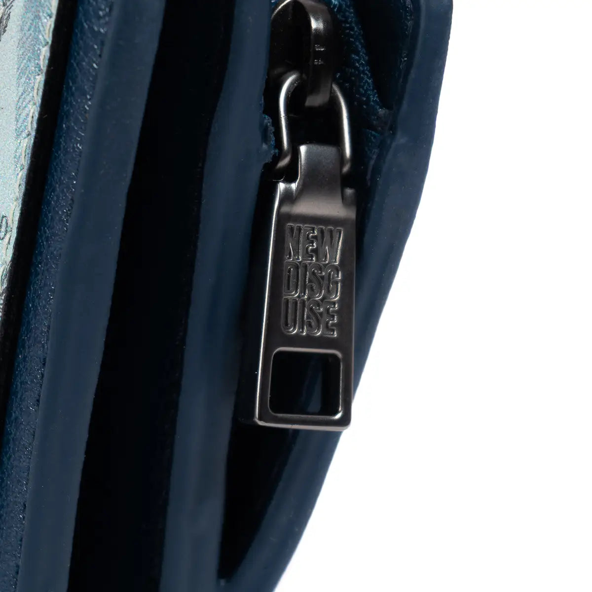 Close up of New Disguise branded zip detail