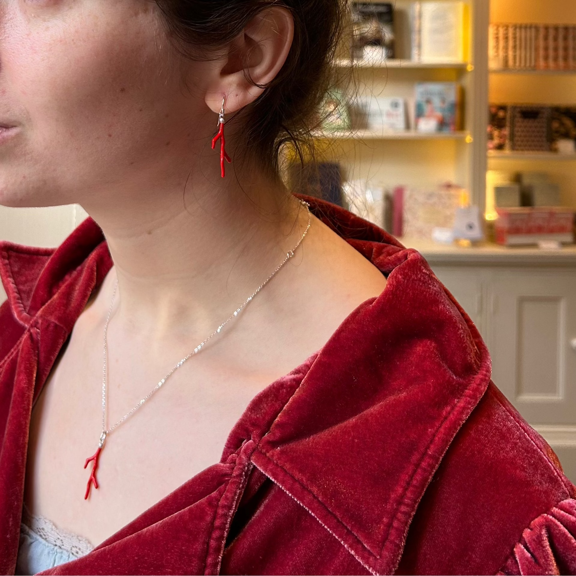 Actress in red regency outfit with red Jane Austen Emma Earrings and necklace