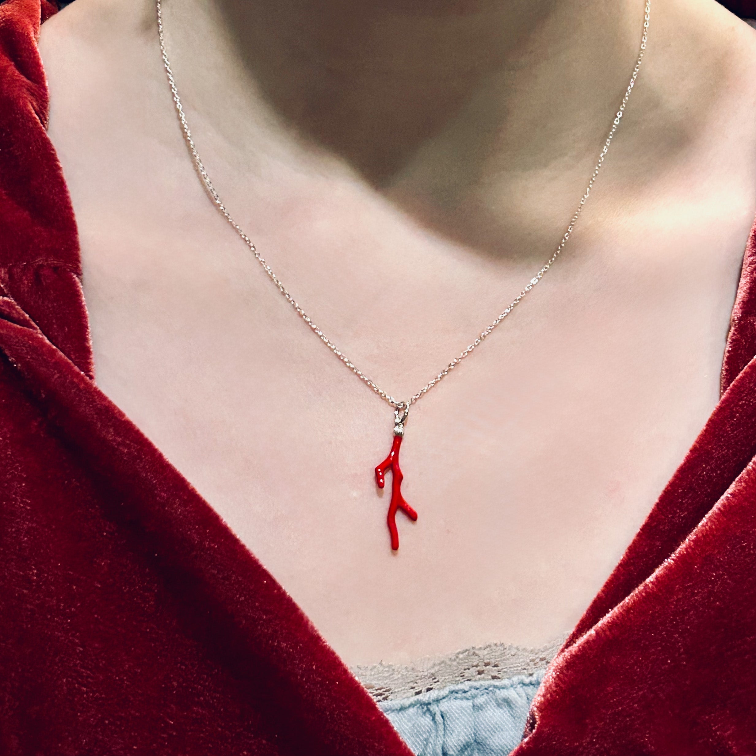 Actress in red dress wearing a red Necklace in the shape of coral