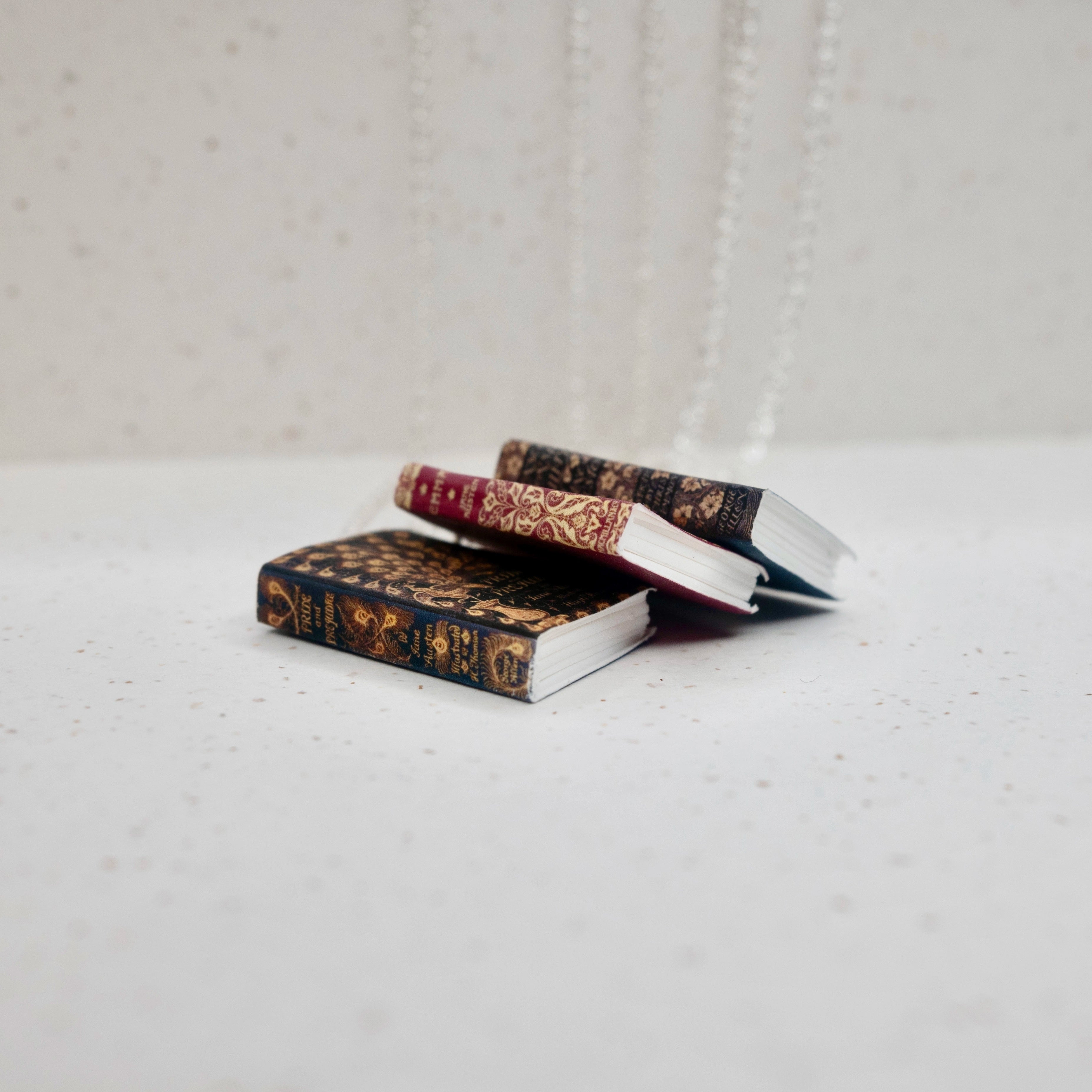 A Pile of Book cover necklaces