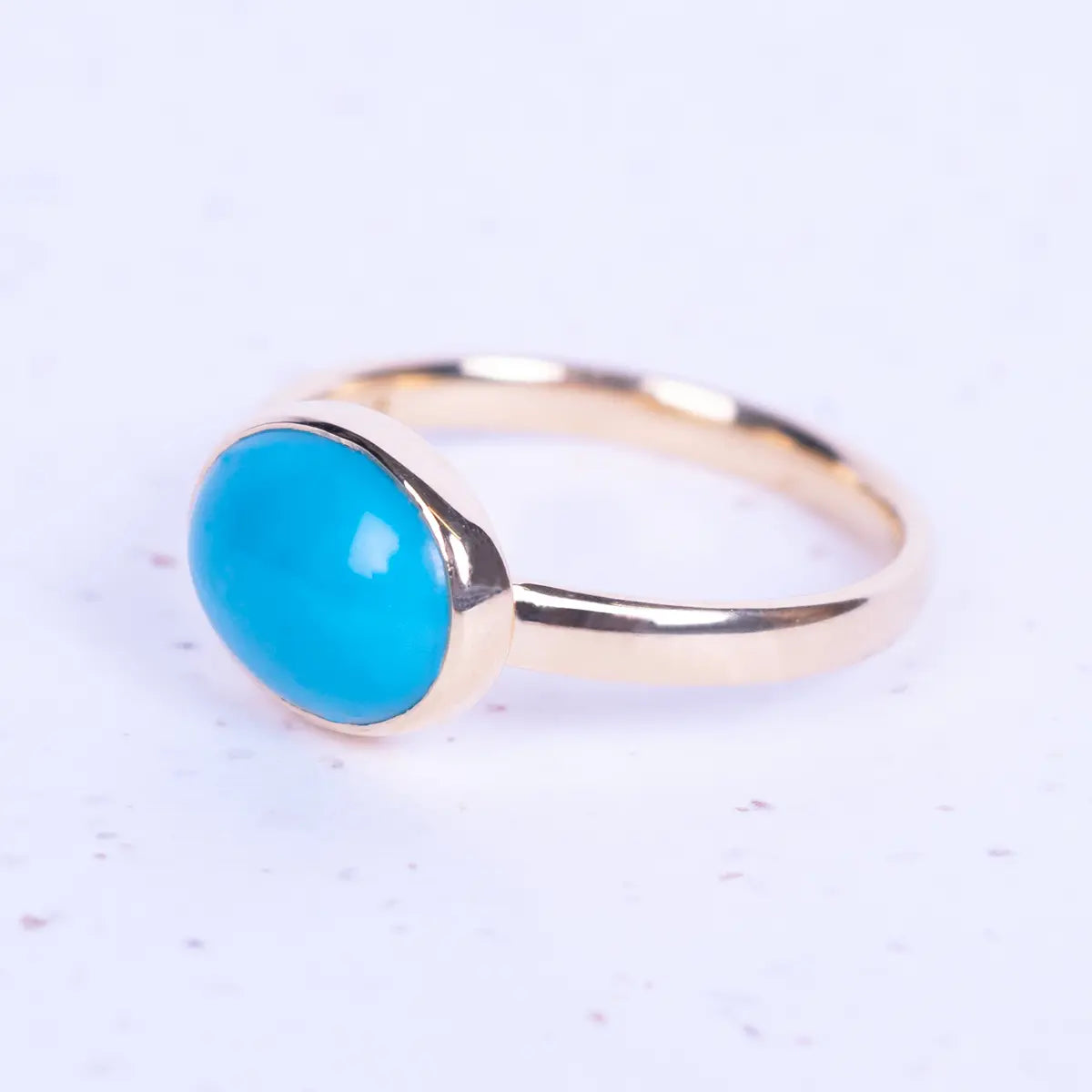 Close up of jane Austens replica turquoise and gold ring