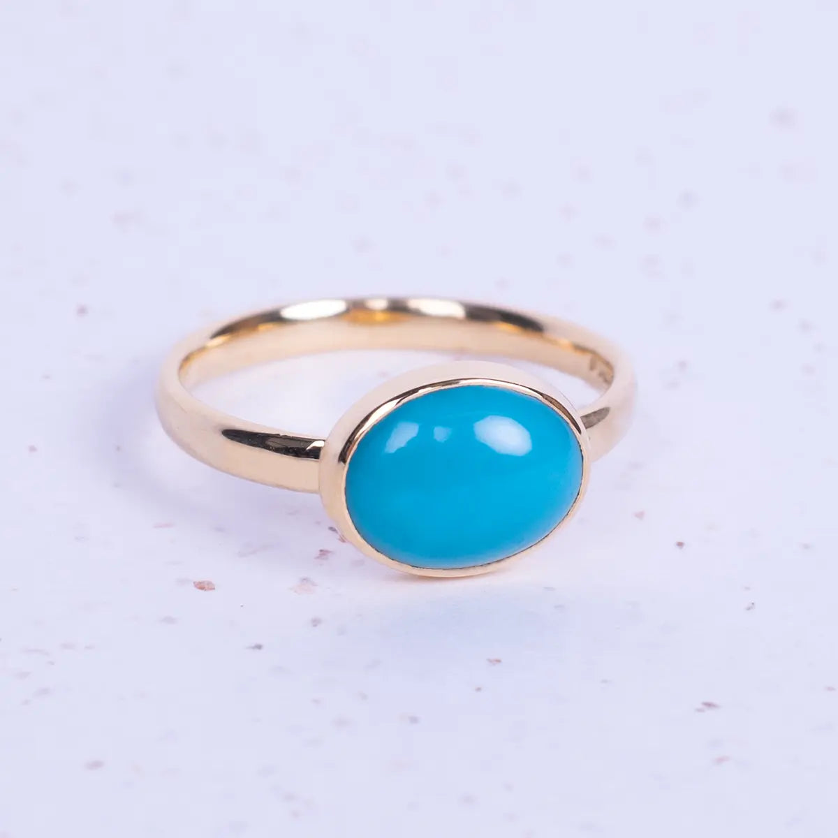 Close up of turquoise and gold ring replica of jane Austens