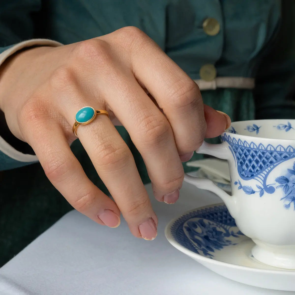 Gold ring with turquoise inlay and teacup