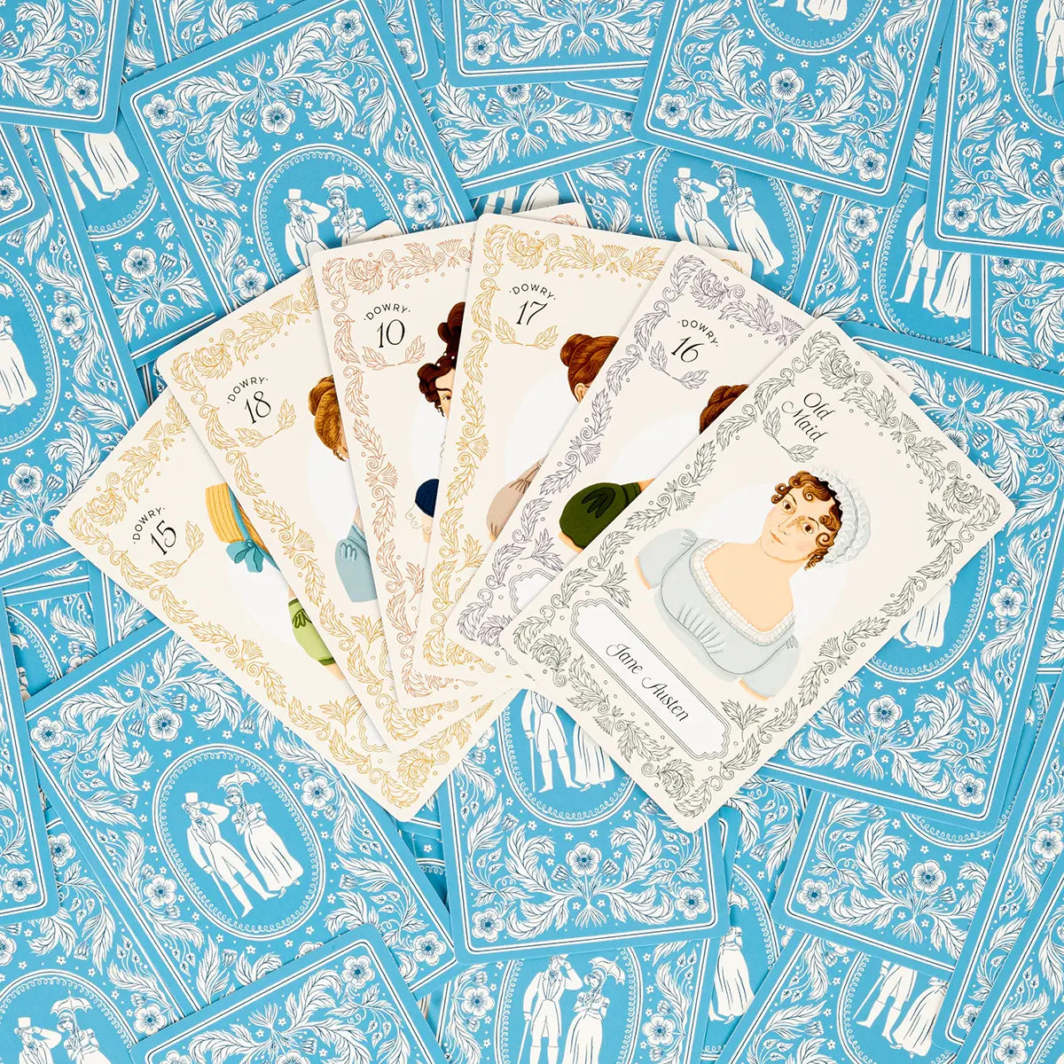 Dowries and Dalliances cards fanned on top of other cards