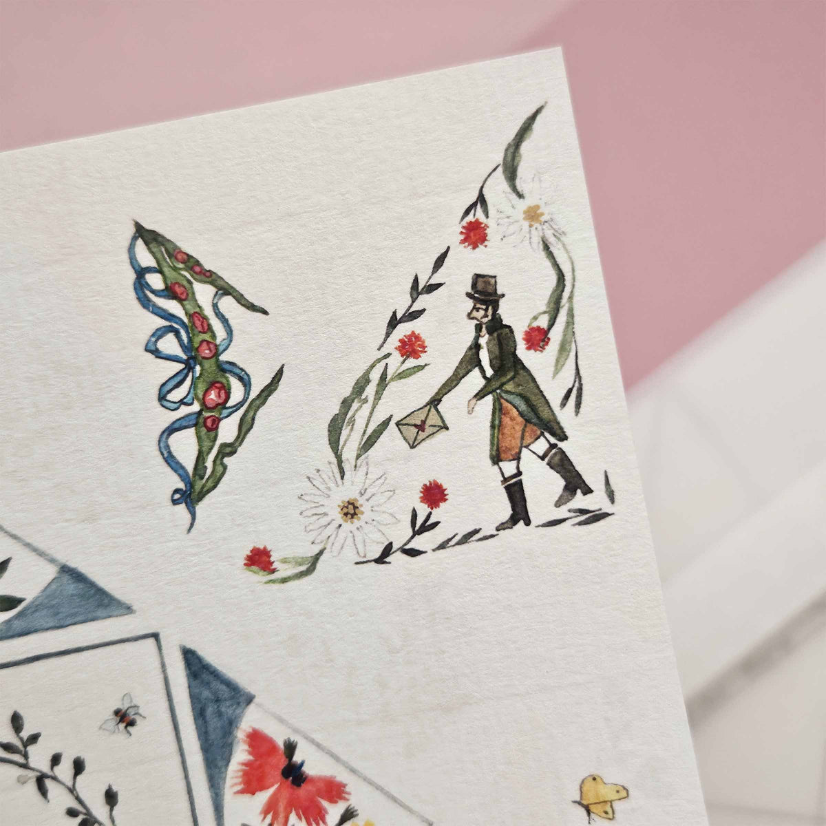 Decorative paper with illustrations of a man, flowers, and geometric shapes on a pink background.