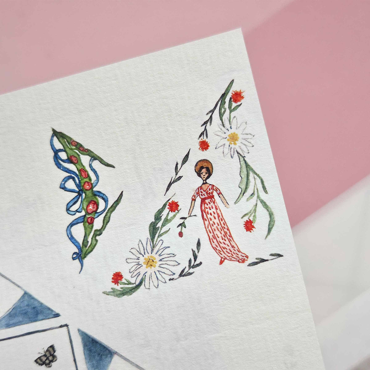 Illustrated design of a woman in a red dress with flowers on a white paper against a pink background
