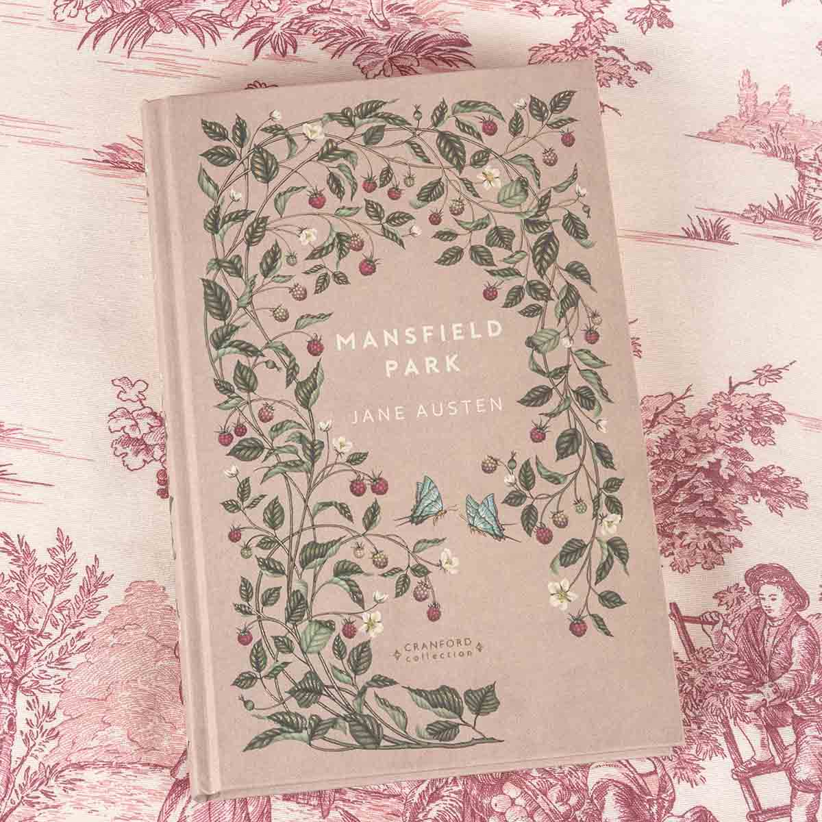 Front cover is beige with strawberry plants and leaves decorating the cover, alongside two blue butterflies