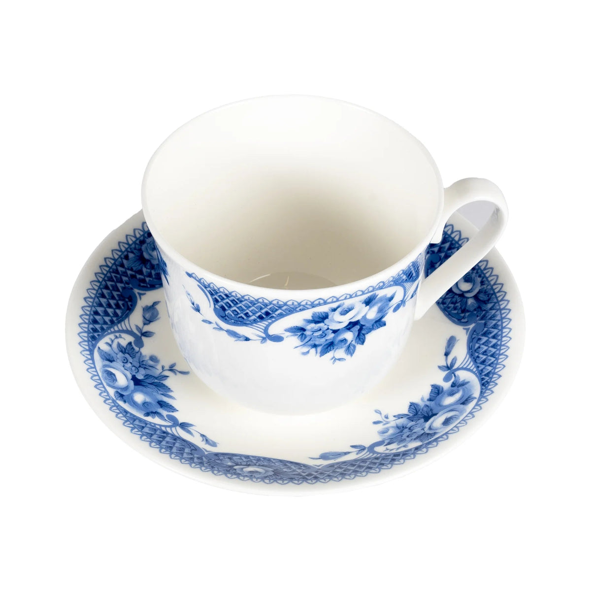White teacup with blue floral patterns on a matching saucer against a white background