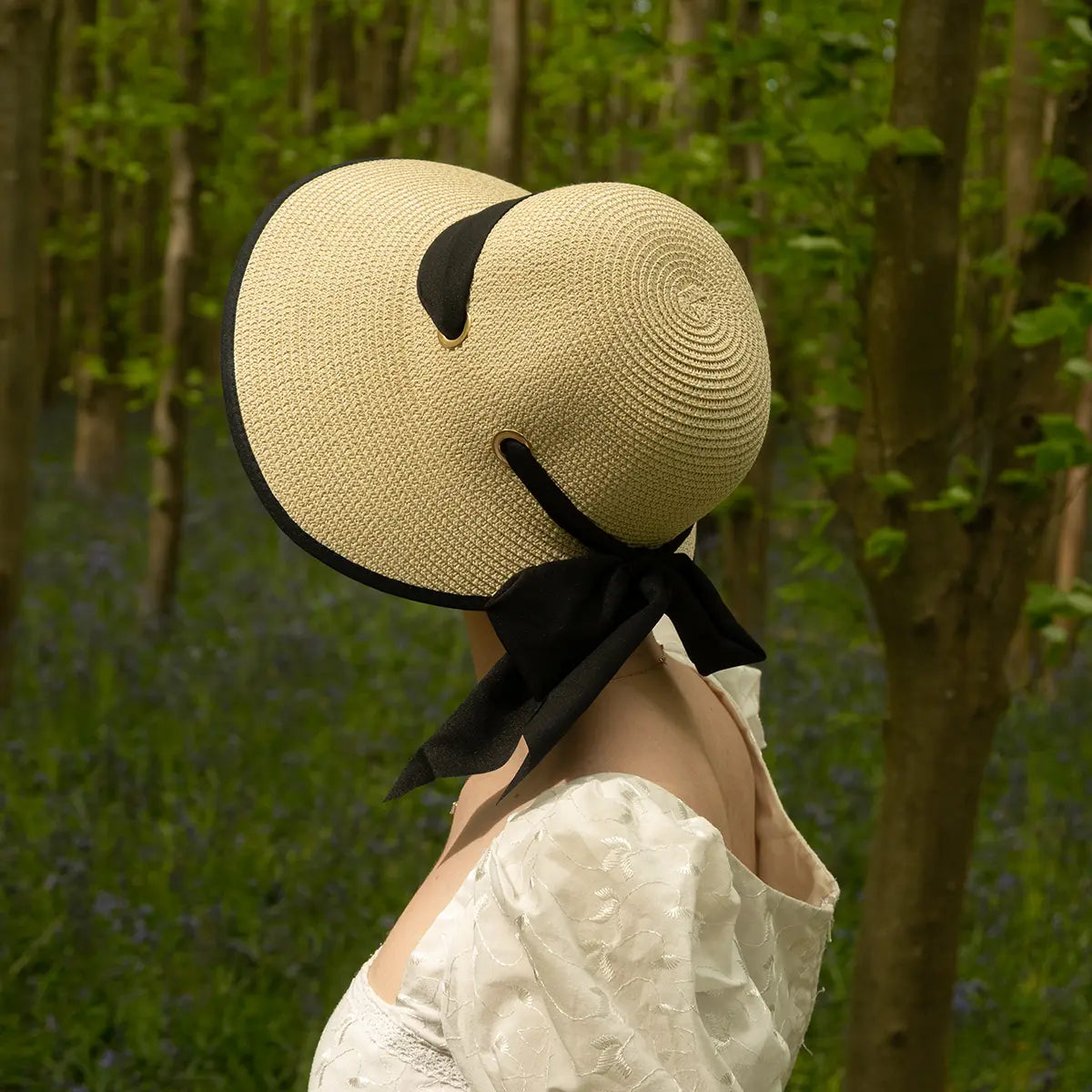 Shot from behind of woman wearing open-back regency bonnet