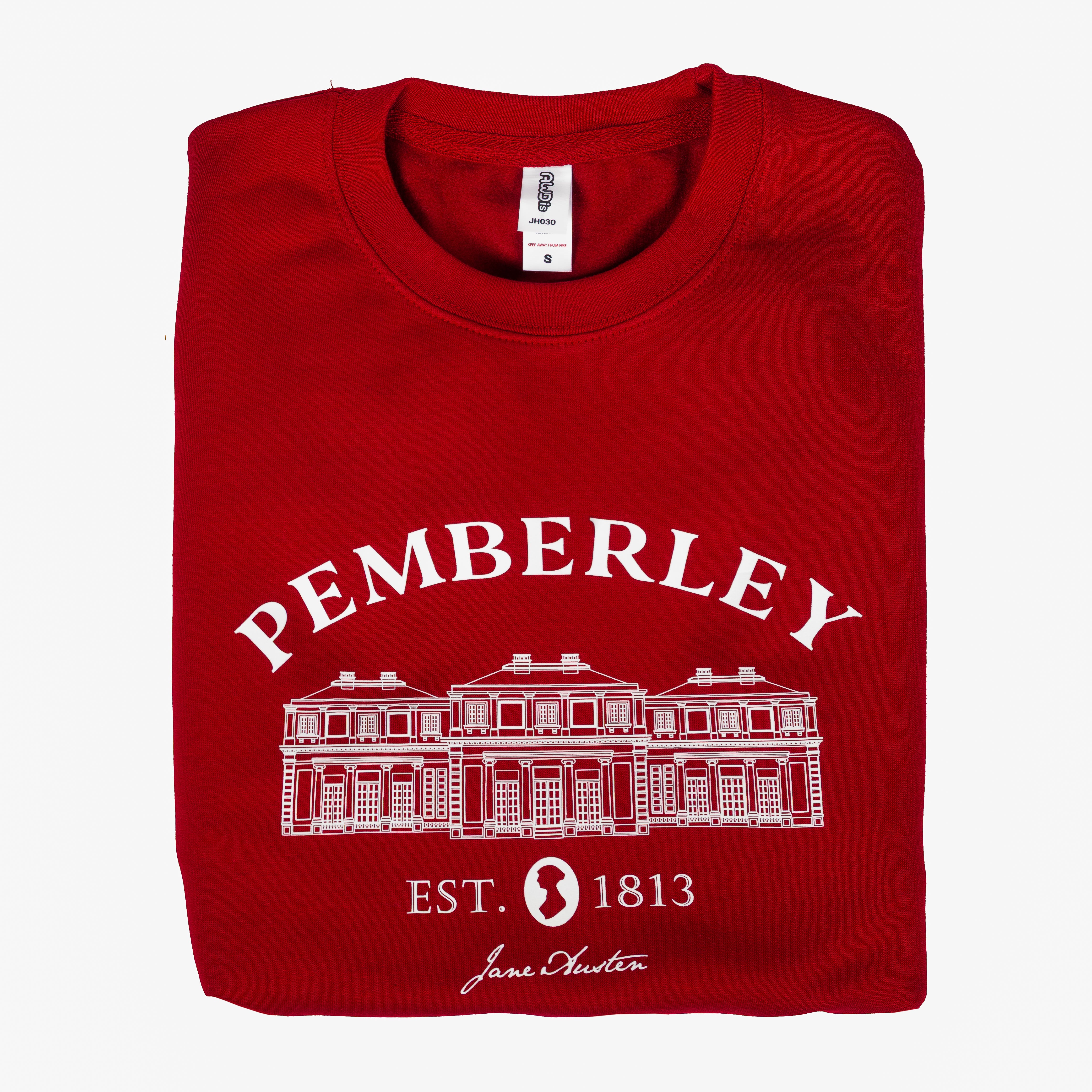 A folded red sweater featuring pemberley text and an image of Pemberley manor against a white background