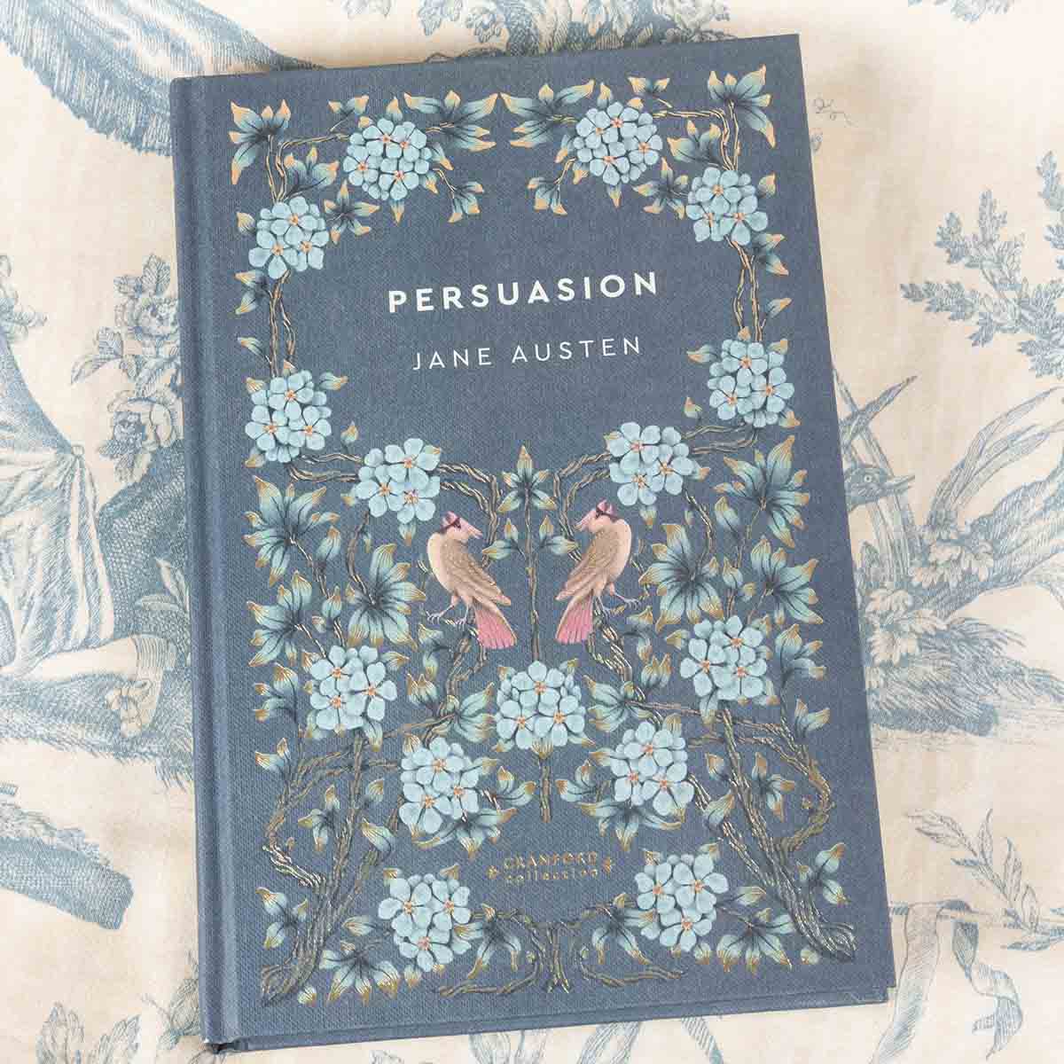 Front cover is washed blue with blue flowers and birds decorating the cover