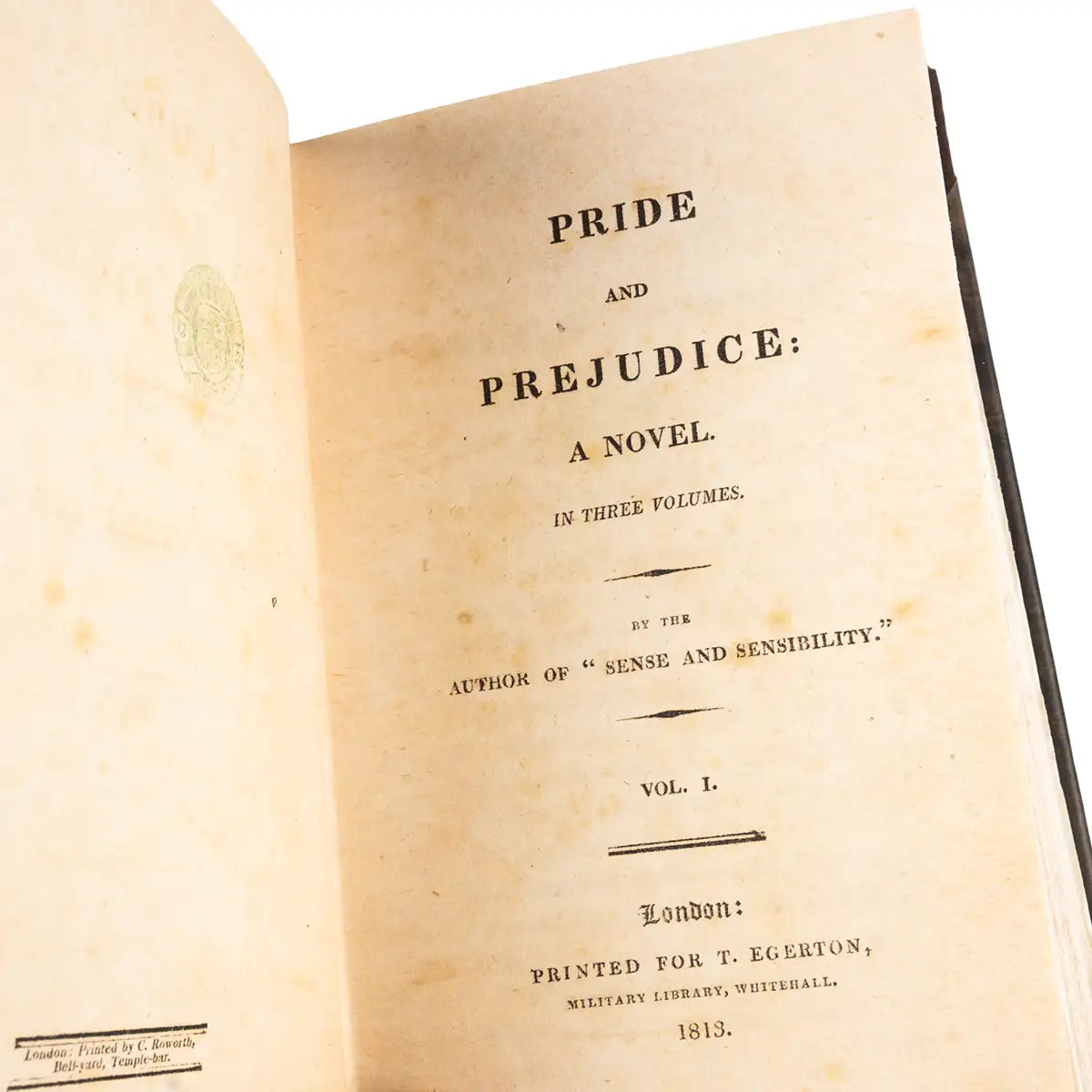 Title page of 'Pride and Prejudice' by Jane Austen from 1813. Paper is stained and speckled like a vintage book.