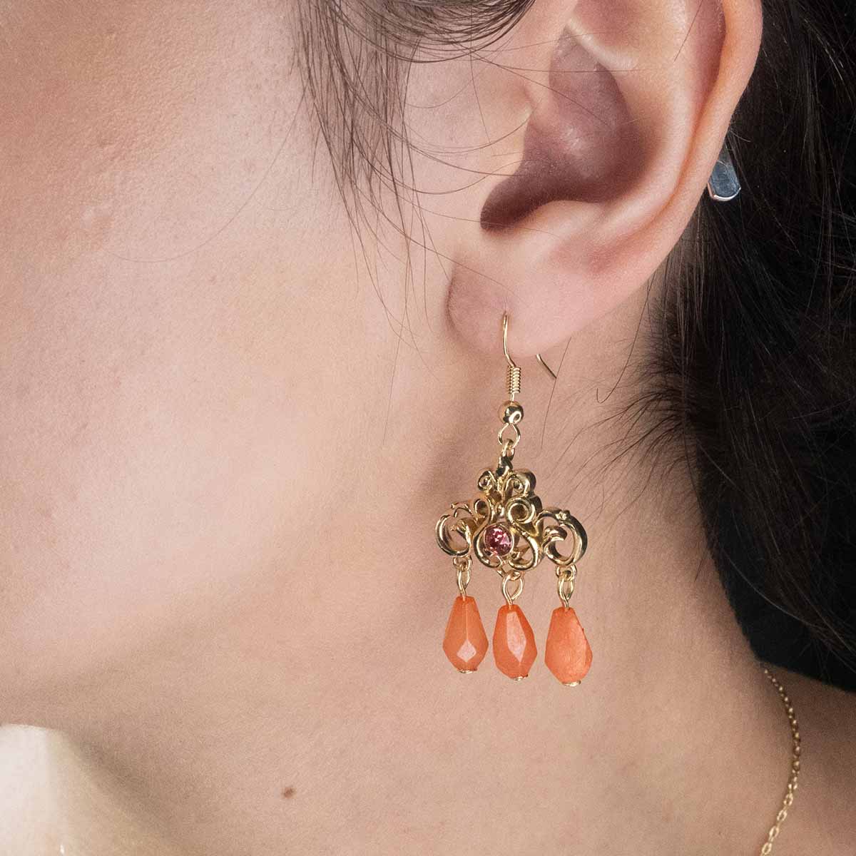 Regency Coral Earring on ear.
