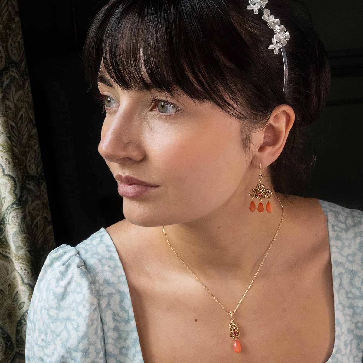 Catherine Morland wearing the Regency Coral Necklace and Earrings